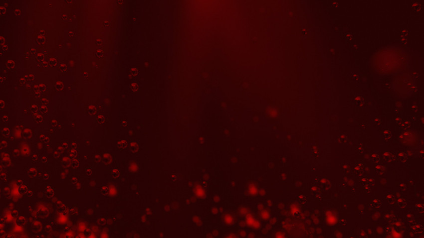 Red background with air bubbles underwater.