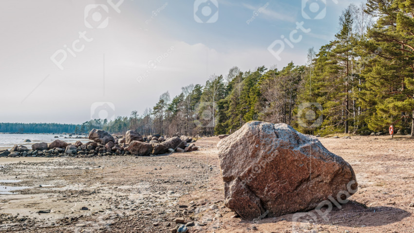 Big granite stone and view on forest near the sea