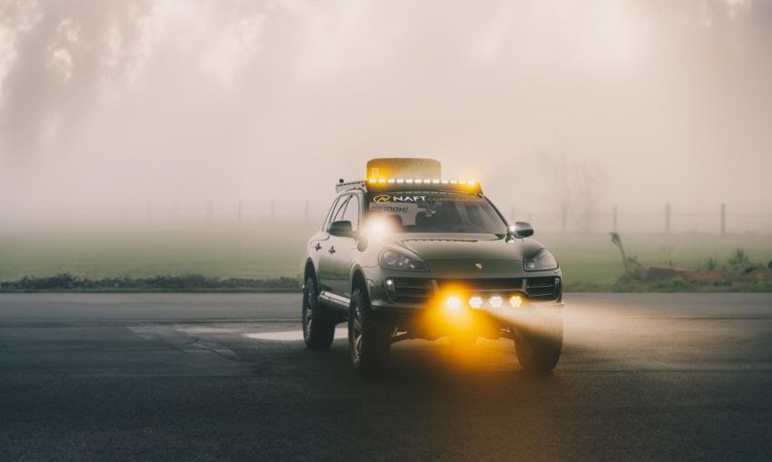 car driving on a road with fog in the background