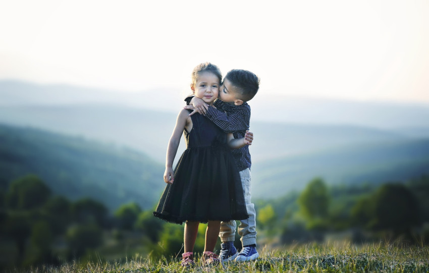 Children, a boy kisses a girl