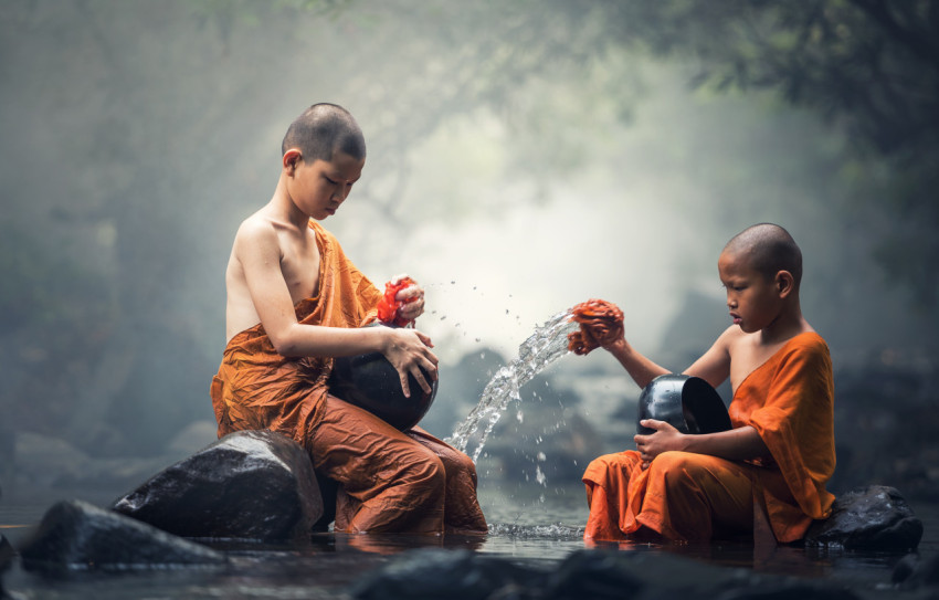 Boys washing dishes in the river