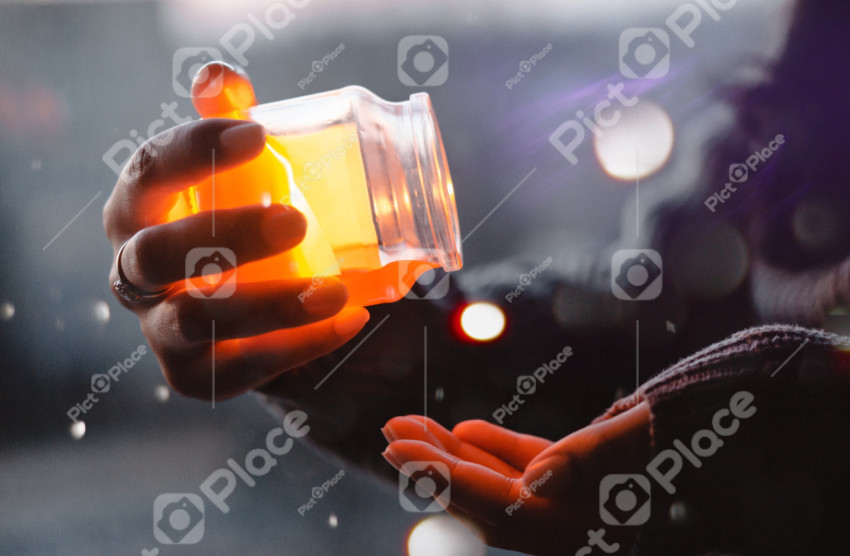 Man about to pour yellow liquid on the palm
