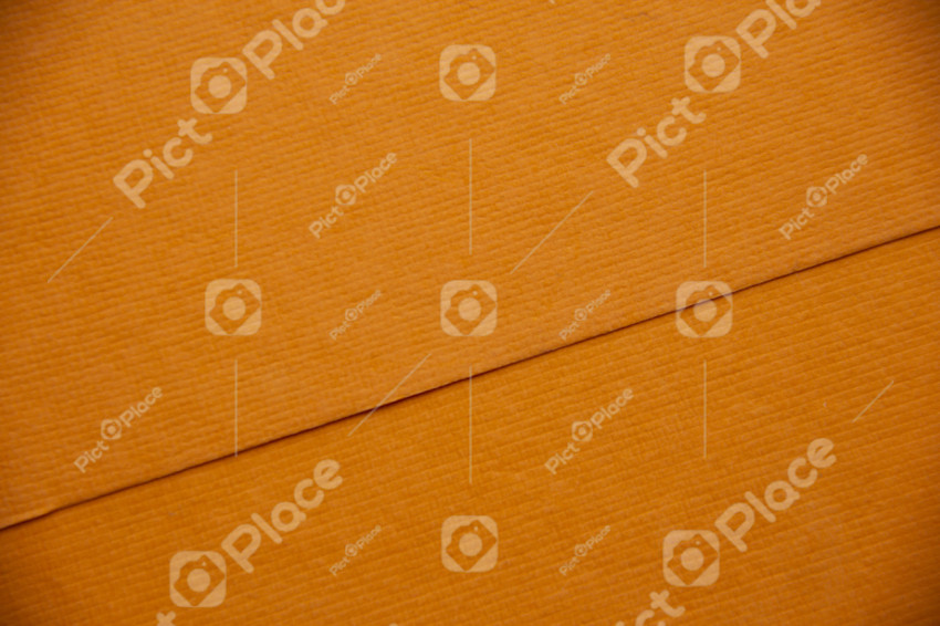 Orange real paper texture. The lines are angled. The pattern is like squares. Two sheets on top of each other