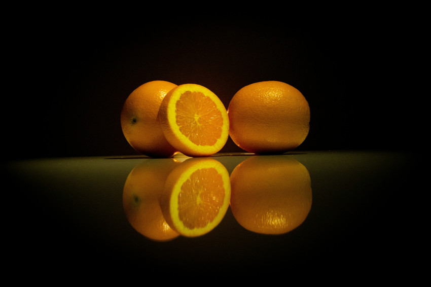 a group of oranges on a table