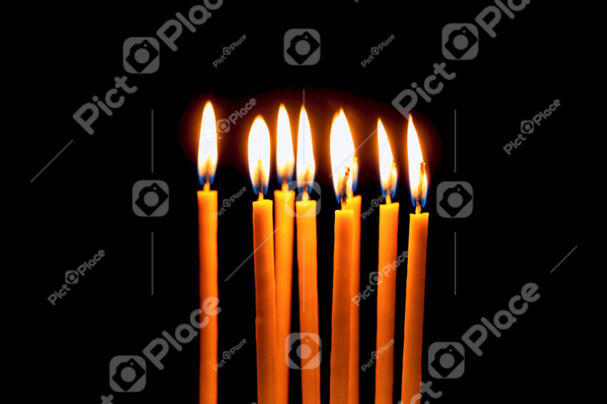 Thin yellow burning candles. Church candles
