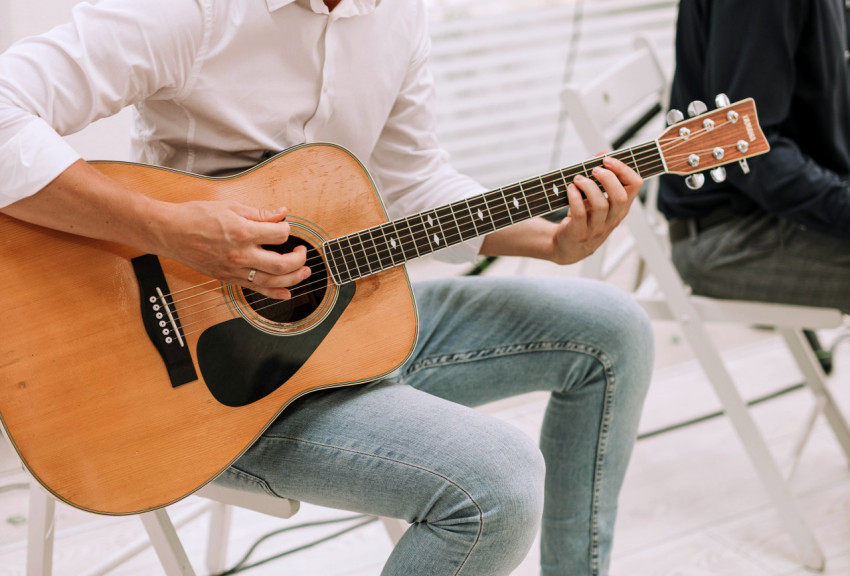 Guy playing the guitar close up