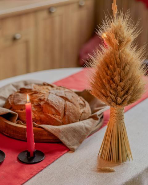 table topped with a loaf of bread and a candle