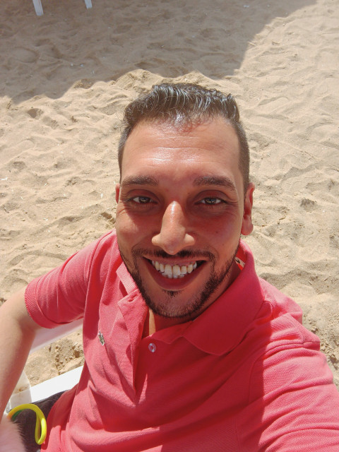 Natural images of the sun's rays perpendicular to a smiling face in the background of sand