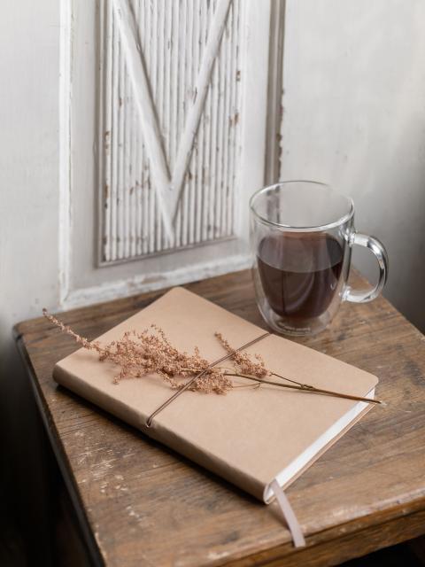 cup of coffee and a book on a table