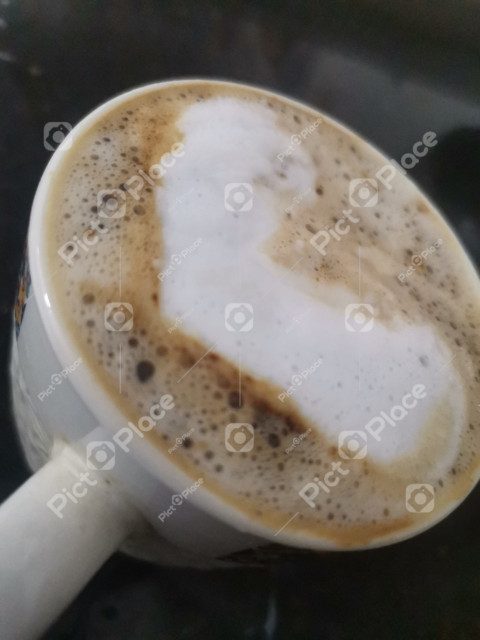 Cup of coffee with heart shaped foam