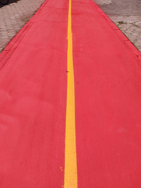 Freshly painted and empty red bike path.