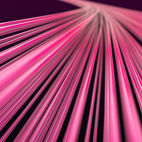 Abstract background with many pink lines or wires extending into perspective and blurring against a dark purple background.
