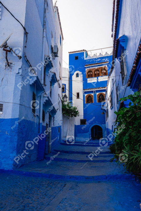 Narrow alley with buildings painted blue